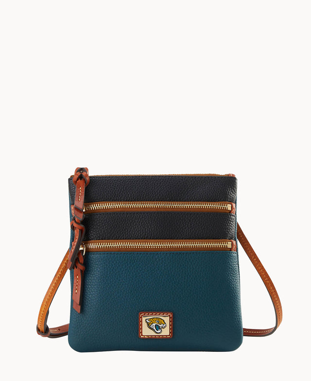 A small crossbody bag with a brown adjustable strap, two zippered compartments on the front, and color-blocked sections in dark teal and black pebbled leather, featuring a small logo patch at the bottom.