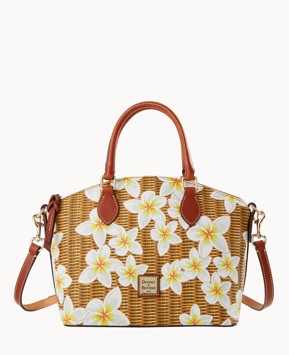 A handbag with brown leather handles and a detachable shoulder strap, featuring a woven rattan pattern and white plumeria flowers with yellow centers printed on the exterior.