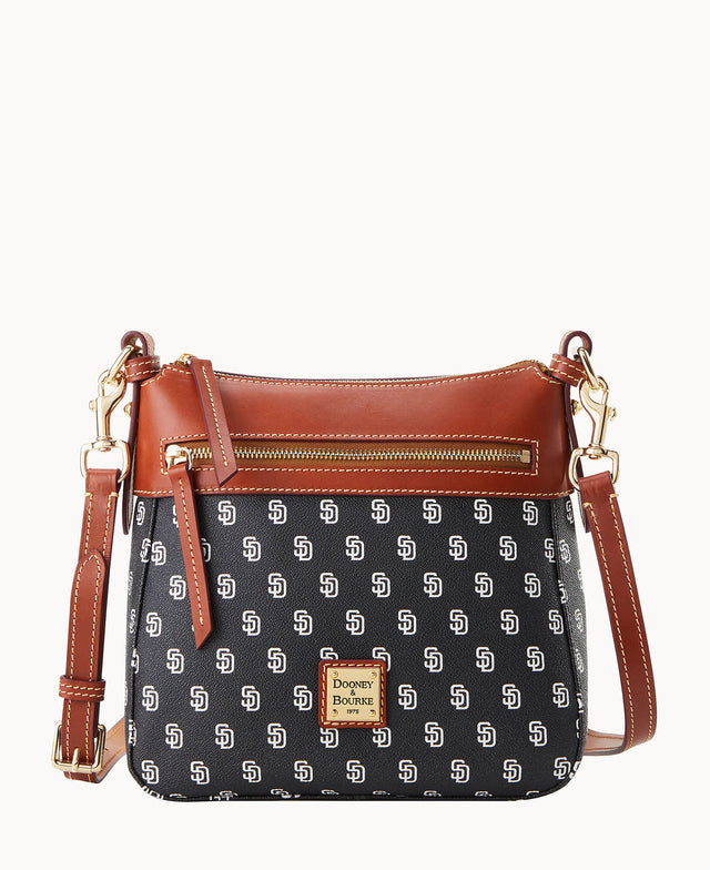 A black crossbody bag with brown leather trim, gold-tone hardware, and a front zipper pocket. The bag features a repeating SD pattern and a Dooney & Bourke logo plate on the front.