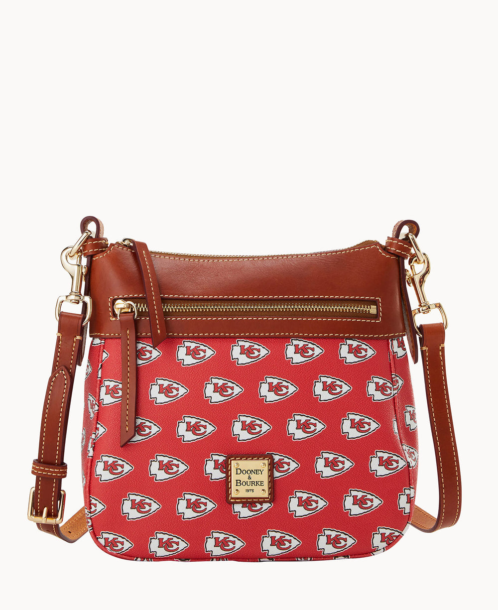 Red Kansas City Chiefs crossbody bag with repeating team logos, brown leather handles and gold hardware