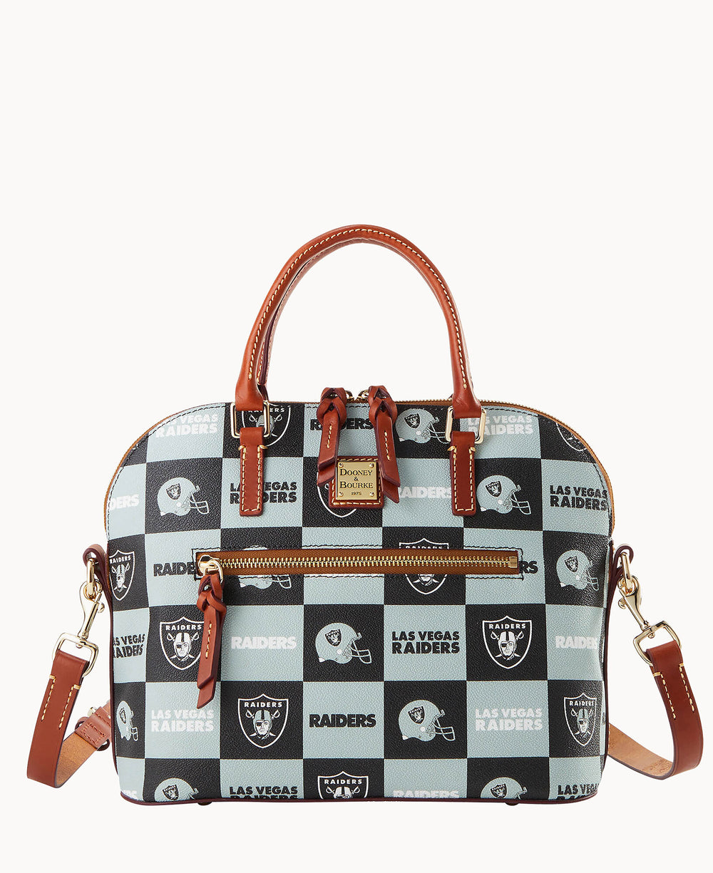 A checkered handbag with tan leather handles and trim, decorated with black and white Las Vegas Raiders logos and text. The bag has a front zipper pocket and a detachable shoulder strap.