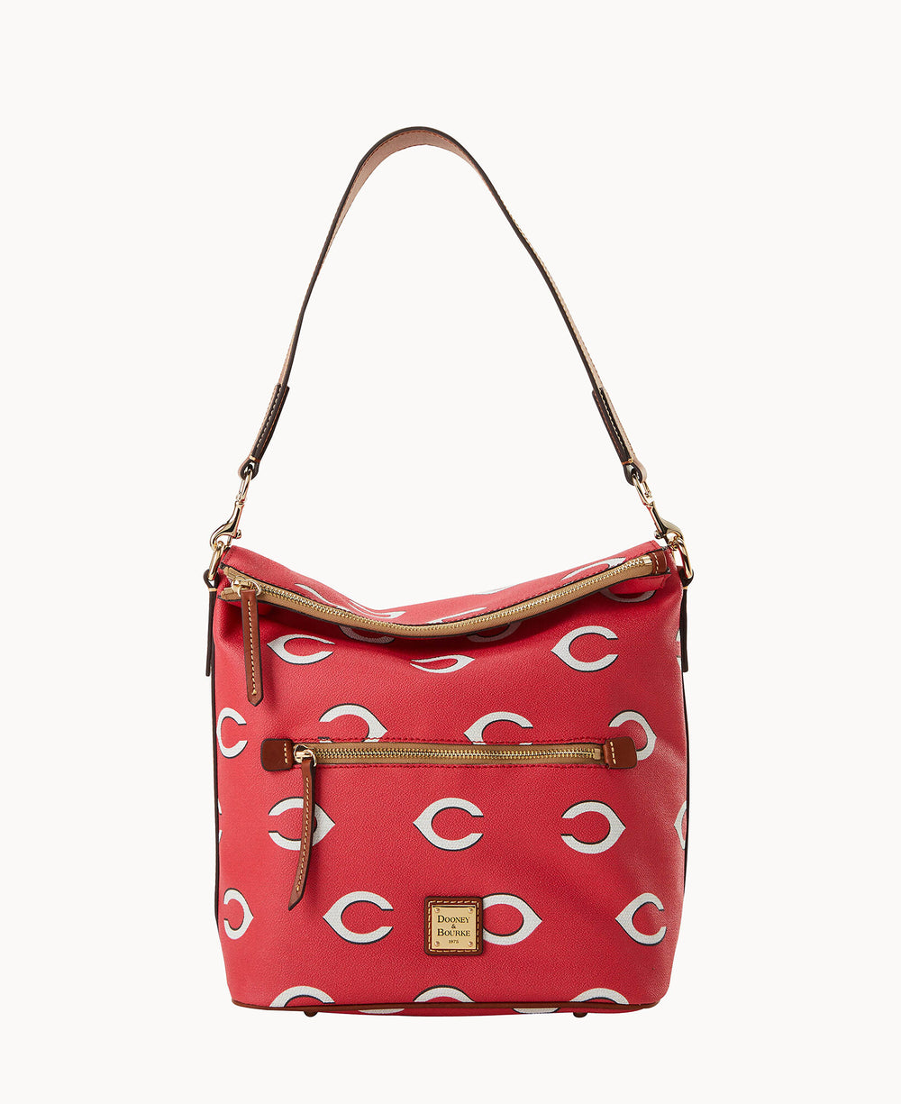 A red shoulder bag with a brown strap, gold zippers, and white crescent patterns. The front features a small rectangular gold Dooney & Bourke logo plaque and an exterior zippered pocket.