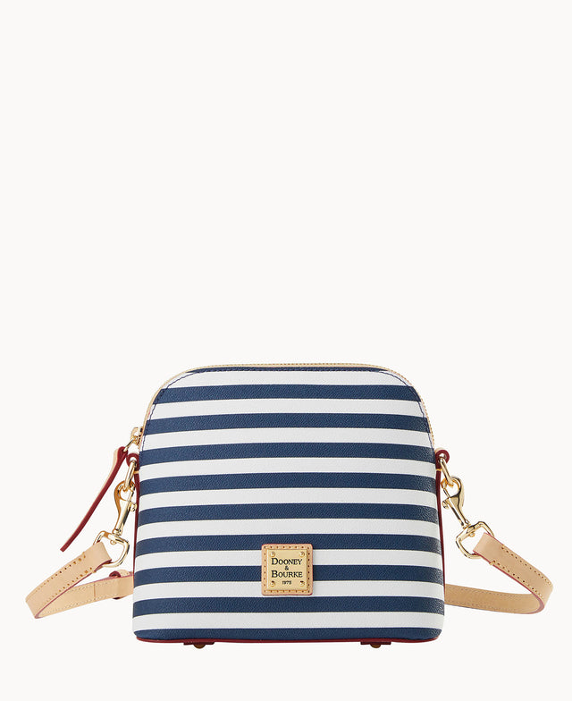 A small crossbody bag with navy blue and white horizontal stripes, gold-tone hardware, tan leather strap and trim, and a gold Dooney & Bourke logo plaque on the front.