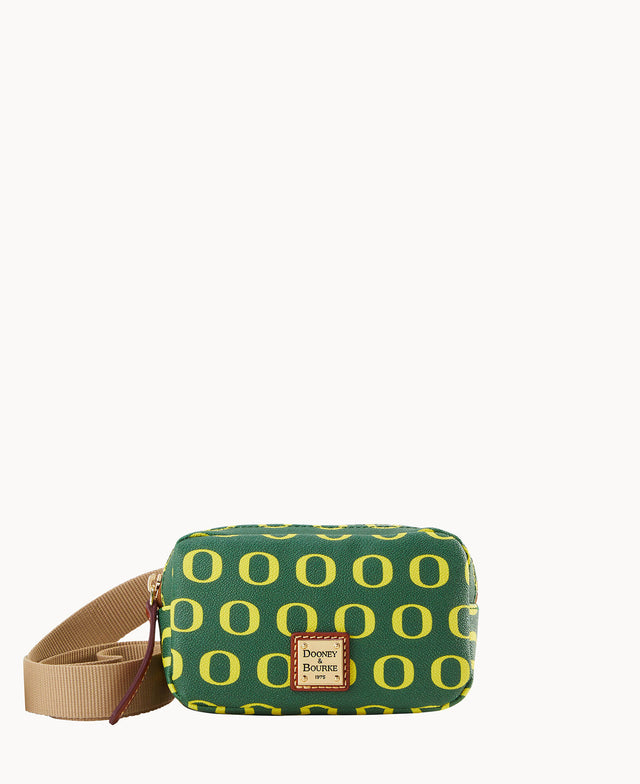 A green crossbody bag with yellow O patterns, a tan adjustable strap, and a Dooney & Bourke logo patch on the front.