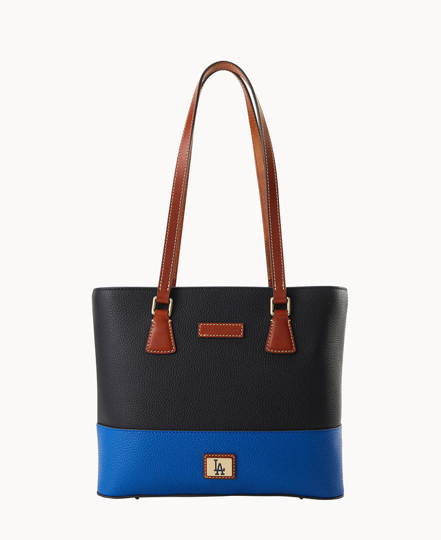 A black and blue textured tote bag with brown leather handles and accents, gold-tone hardware, and a small LA logo patch on the front bottom center.