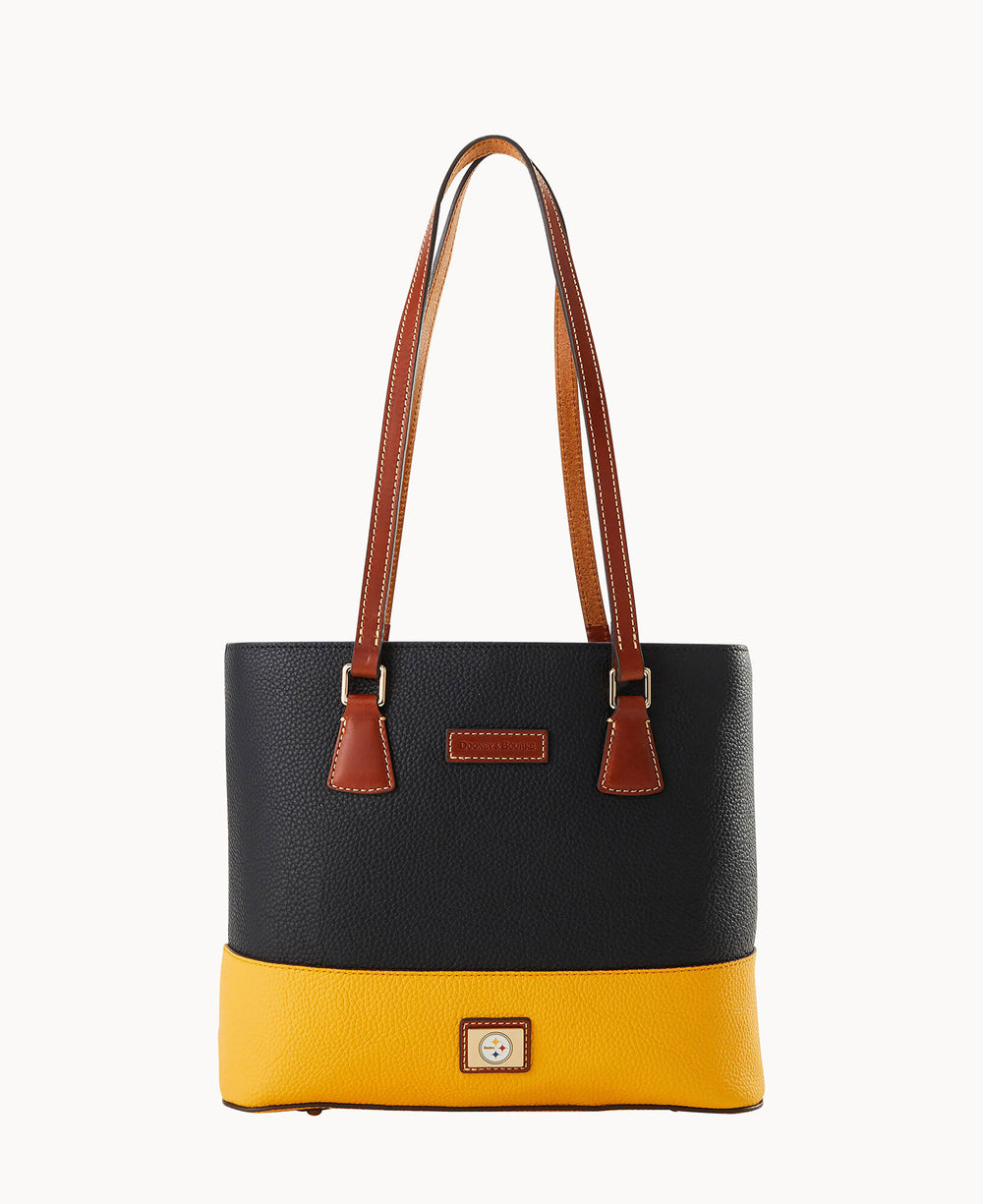 A stylish tote bag with a black upper section, yellow bottom, brown leather handles, and a brown leather patch on the front, set against a plain white background.