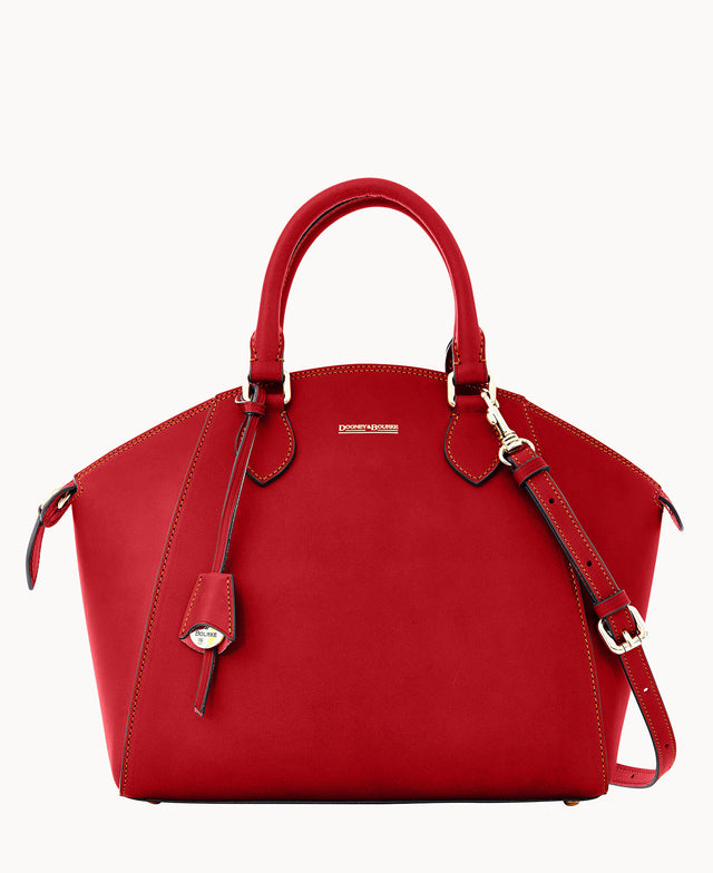 A stylish red leather handbag with dual handles, gold hardware, a removable shoulder strap, and a small hanging tag. The bag features structured sides and visible stitching detail.