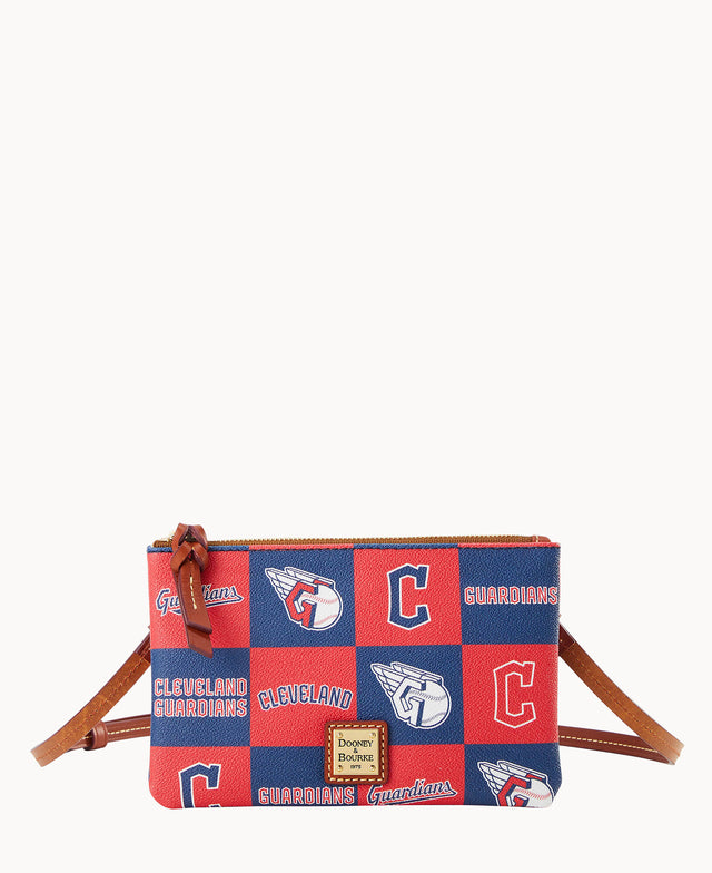A small crossbody bag with a brown strap, decorated with red and blue Cleveland Guardians logos and text. The bag has a gold Dooney & Bourke label on the front and a zipper closure with a leather pull.