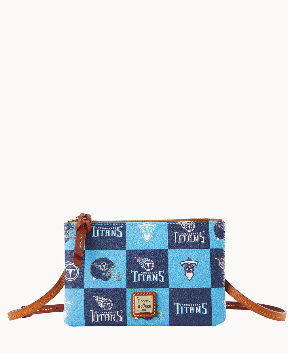A small crossbody purse with a brown strap, decorated in a blue checkerboard pattern featuring various Tennessee Titans logos and text. The purse has a gold zipper and a Dooney & Bourke logo patch on the front.