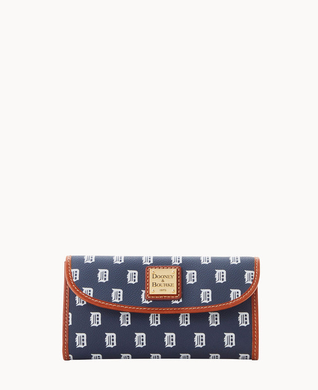 A navy blue Dooney & Bourke wallet with a repeating white D pattern, featuring brown trim and a gold logo plaque on the front.