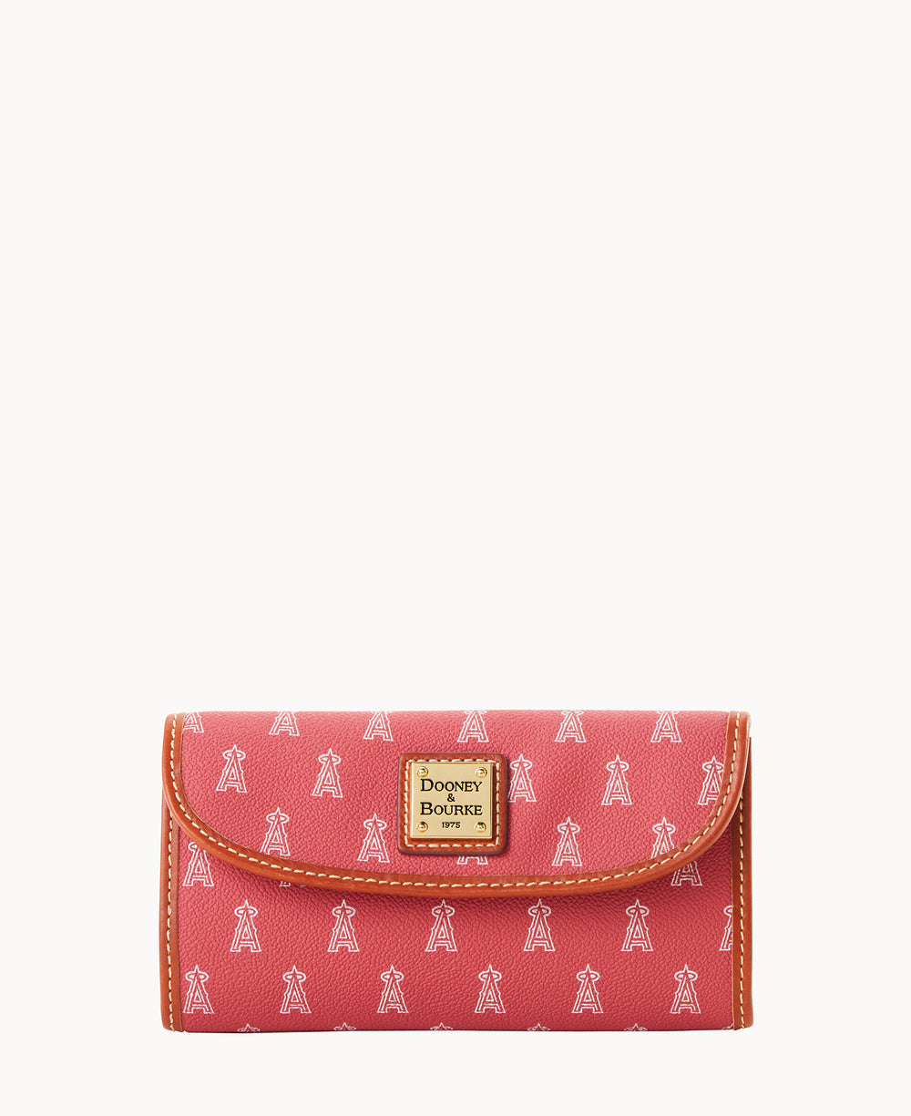 A pink Dooney & Bourke wallet with a brown trim and small white repeating A-shaped icons. The wallet features a gold square logo plaque on the front.