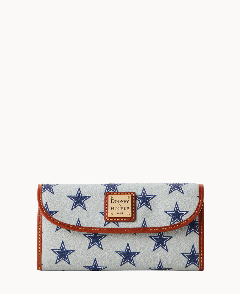 A white wallet with blue star patterns, brown trim, and a Dooney & Bourke logo patch on the front flap.