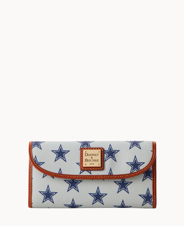 A white wallet with blue star patterns, brown trim, and a Dooney & Bourke logo patch on the front flap.