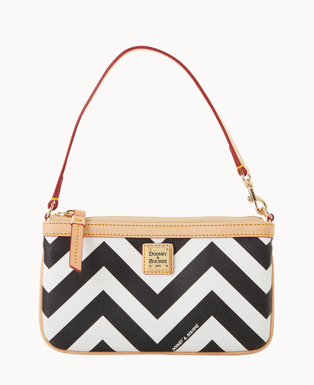 A small handbag with a black and white chevron pattern, tan trim, a gold Dooney & Bourke logo plate, and a red leather strap.