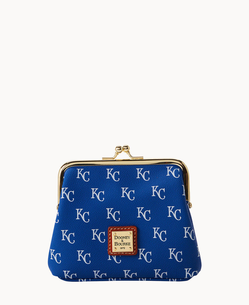 A royal blue coin purse with a gold clasp, featuring a repeating KC pattern and a brown leather Dooney & Bourke label on the front.