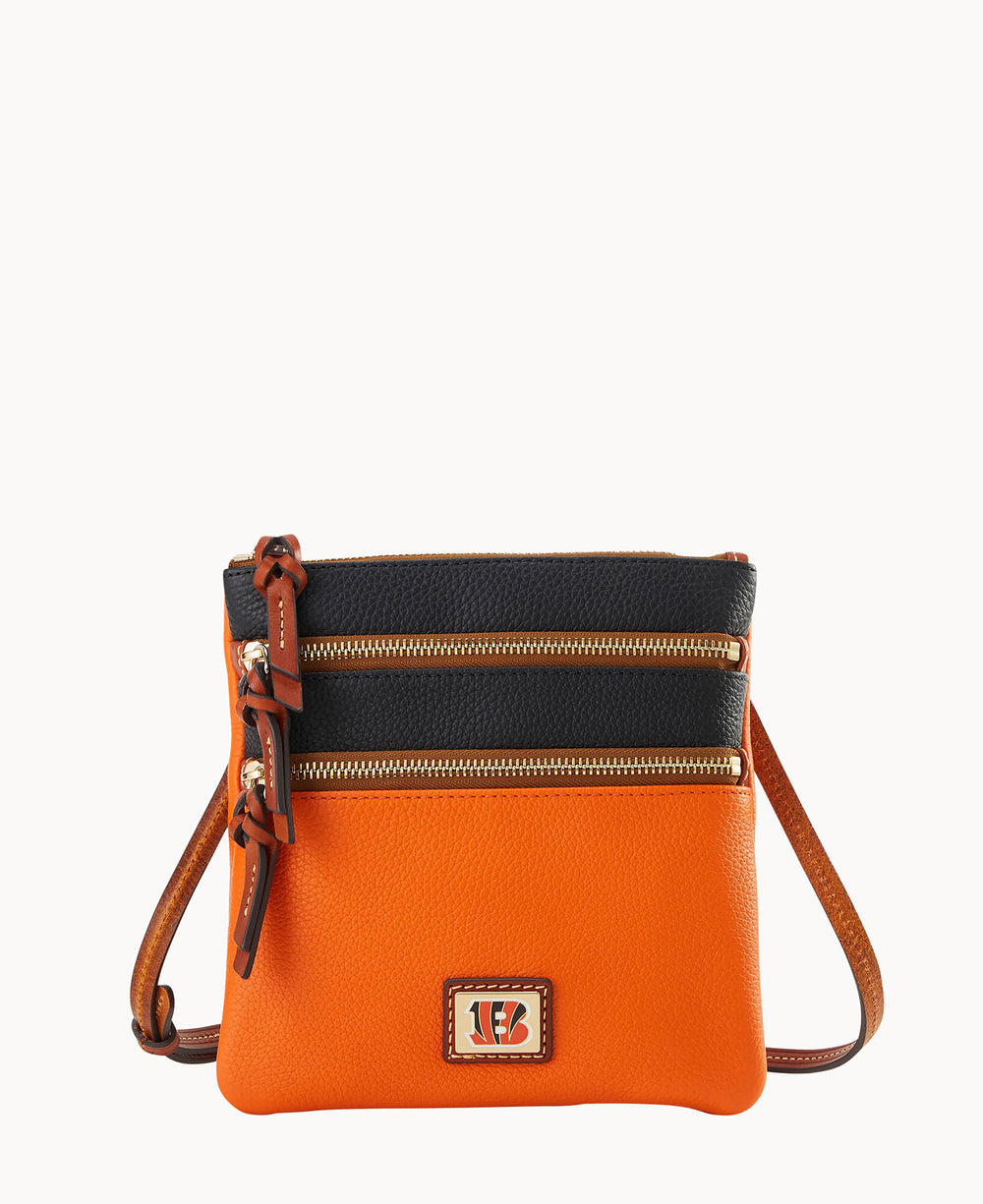 A small crossbody bag with an orange bottom, black top, and brown strap, featuring two zippered sections and a Cincinnati Bengals logo on the front.