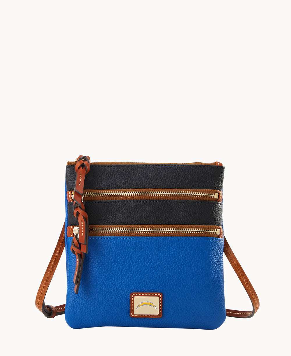 A small crossbody purse with a blue lower section, black upper section, two horizontal gold zippers, brown leather trim, and an adjustable brown strap.