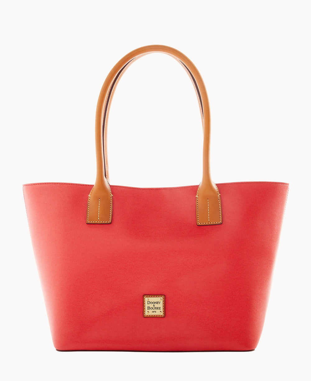 A red leather tote bag with tan handles and a small square Dooney & Bourke logo patch on the front, shown against a white background.