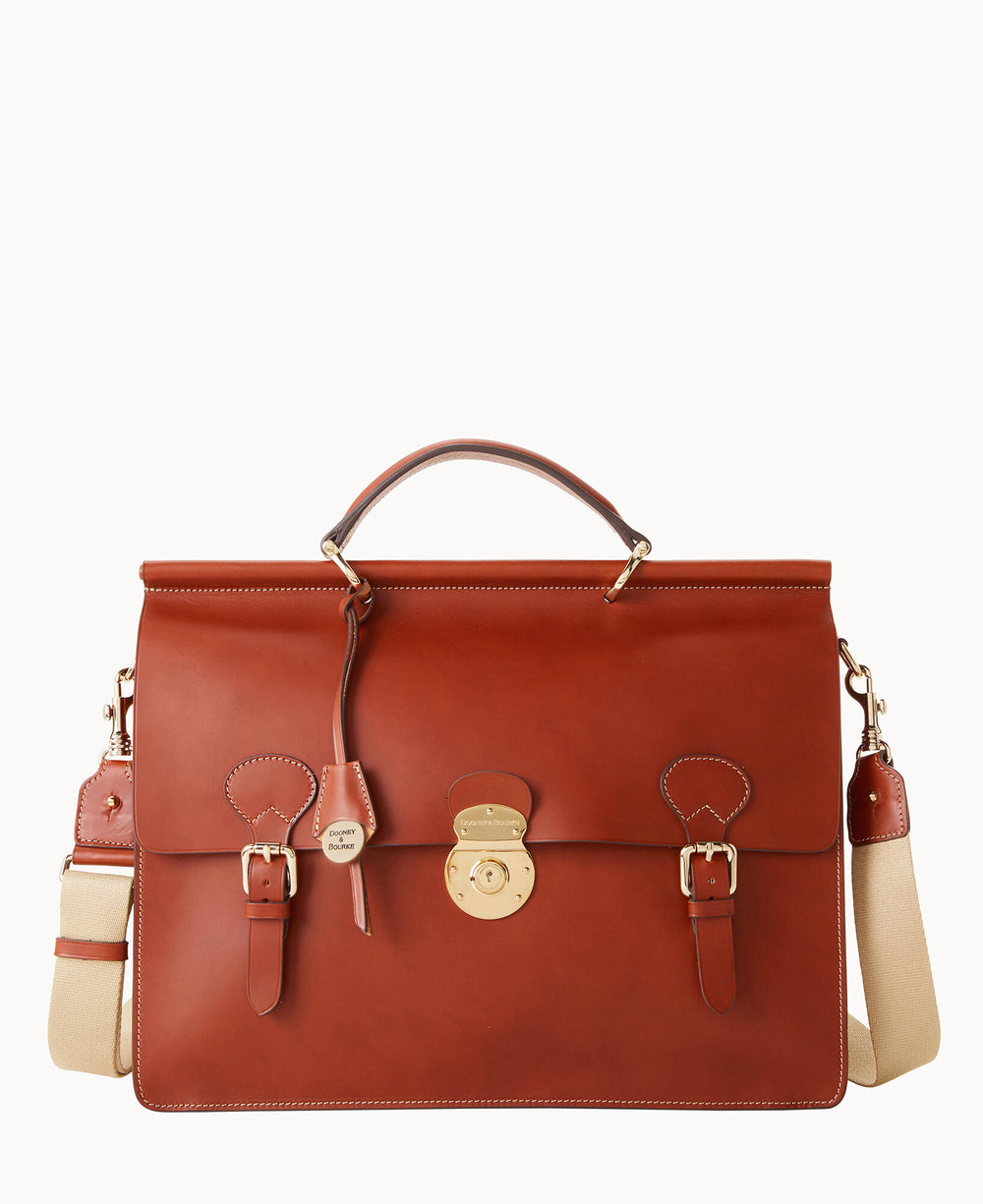 A brown leather satchel with a top handle, gold hardware, front buckle straps, a central lock, and an adjustable beige shoulder strap against a plain white background.