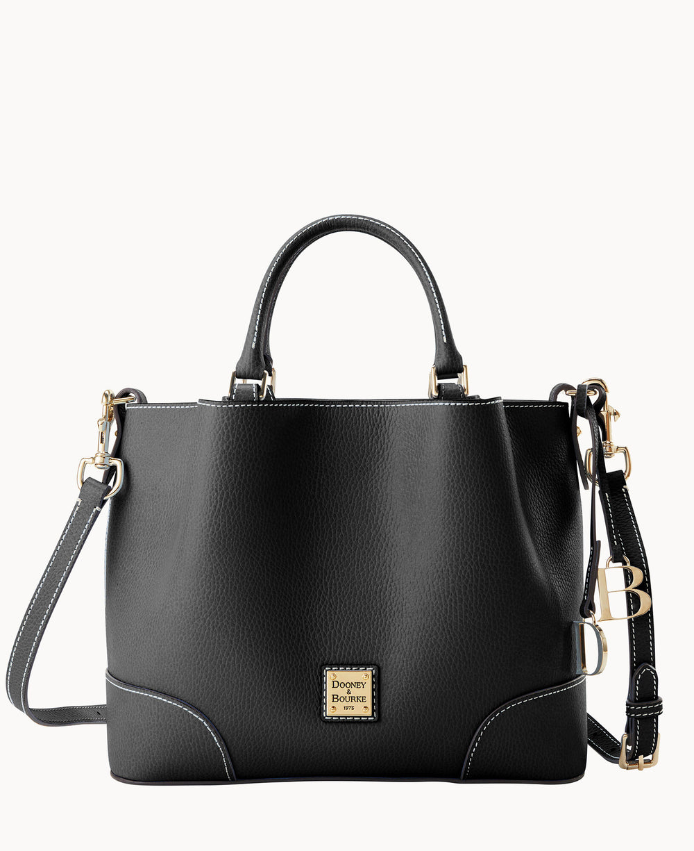 A black leather handbag with gold hardware, dual top handles, a detachable shoulder strap, and a gold Dooney & Bourke logo plaque on the front. White stitching accents the edges. The background is plain white.