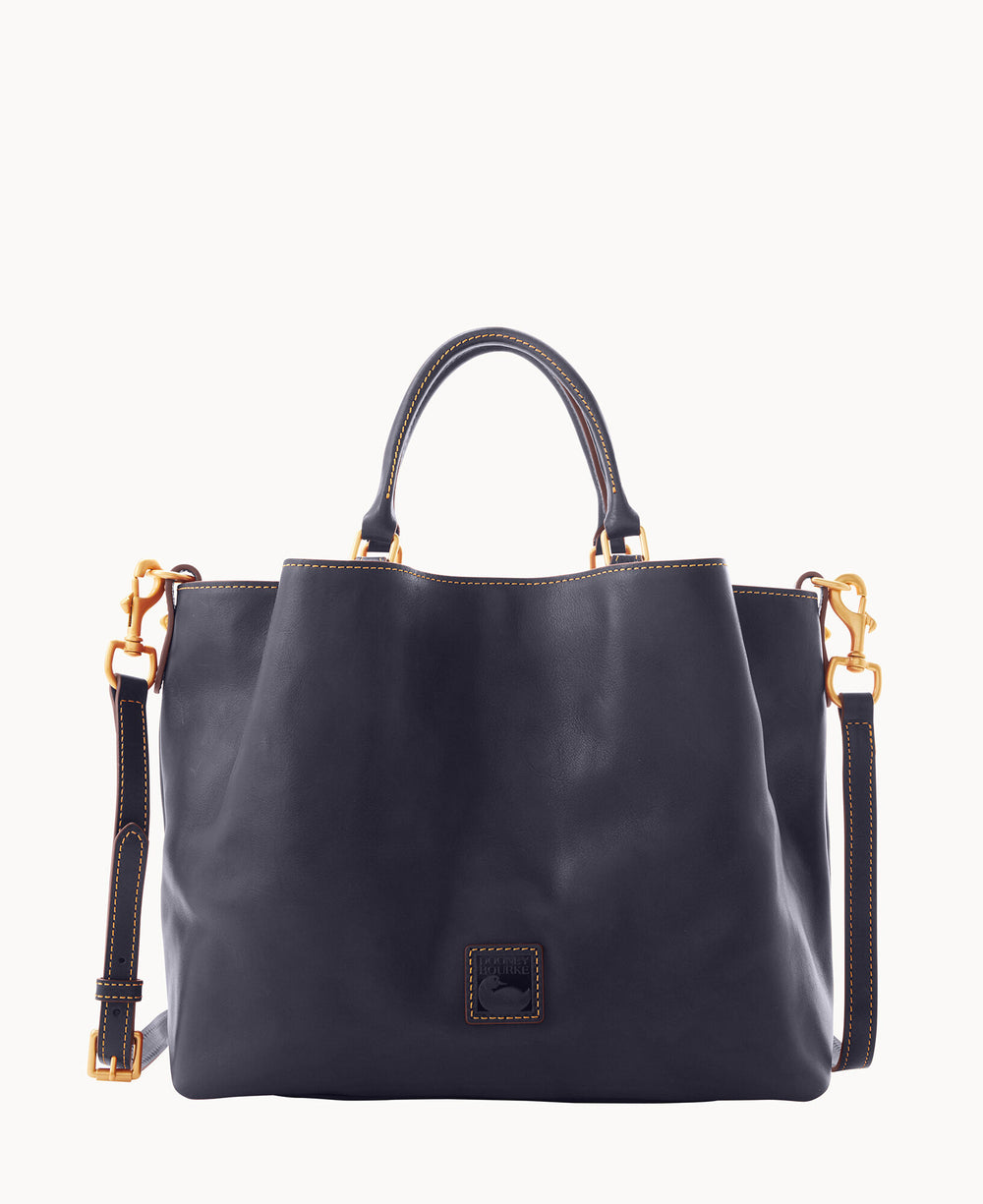 A navy blue leather handbag with gold hardware, matching stitching, two short handles, a long adjustable shoulder strap, and a small square logo patch on the front.