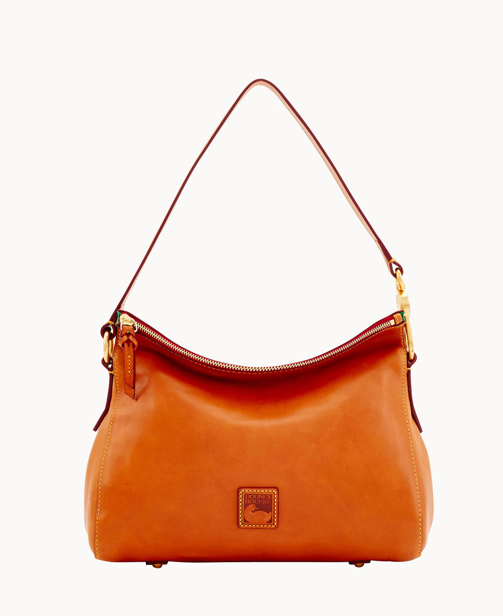 A tan leather shoulder bag with a single strap, gold-tone hardware, a zipper closure, and a small rectangular logo patch on the front. The background is white.