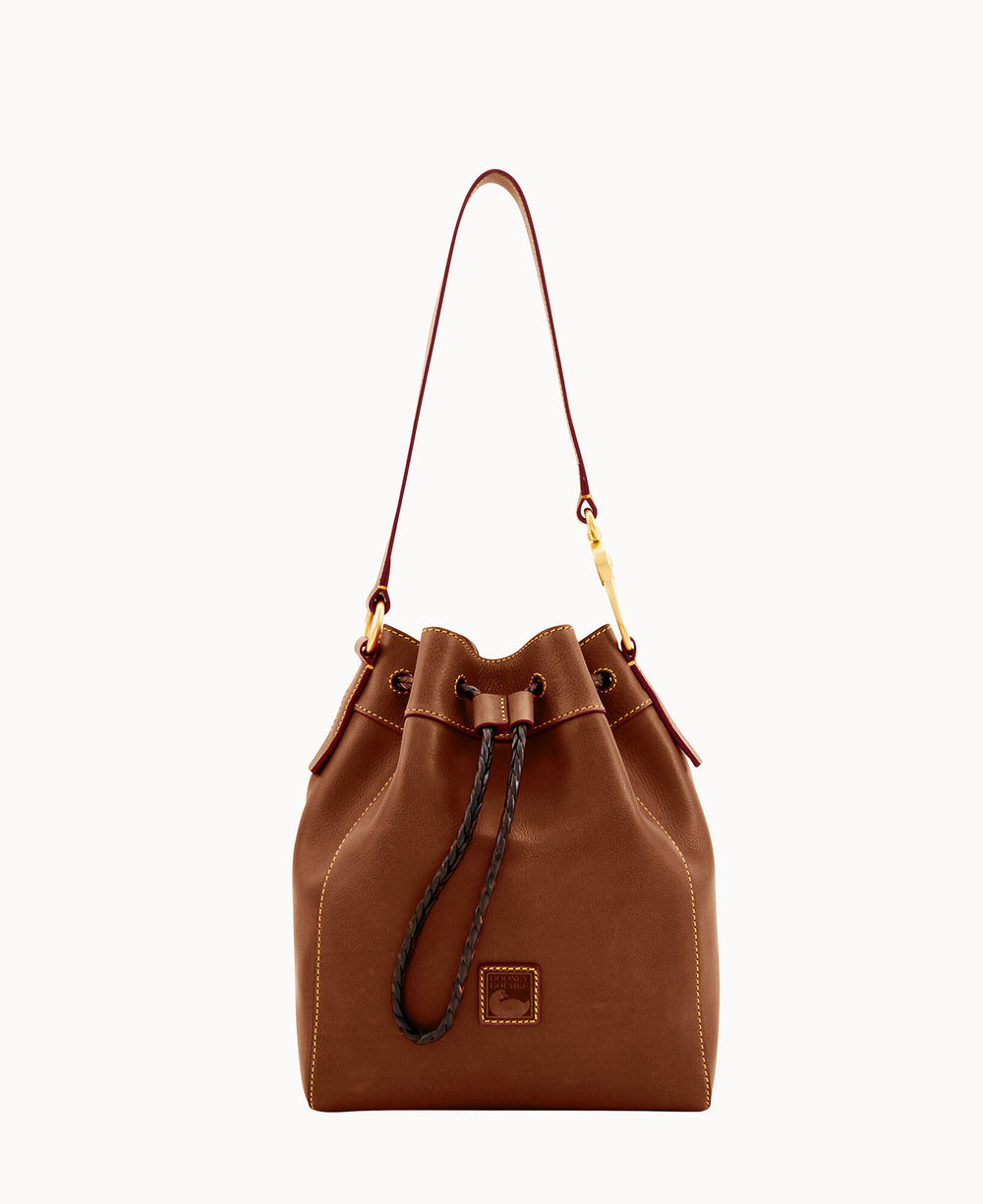 A brown leather bucket bag with a drawstring closure, gold-tone hardware, and a single shoulder strap, set against a plain white background.