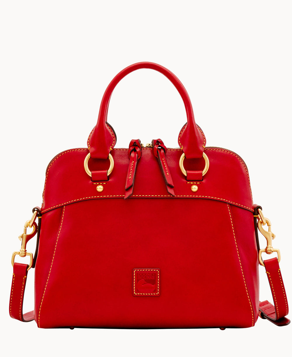 A bright red leather handbag with gold hardware, dual top handles, a detachable shoulder strap, and visible stitching. The bag features a top zipper closure with two zipper pulls and a small logo patch on the front.