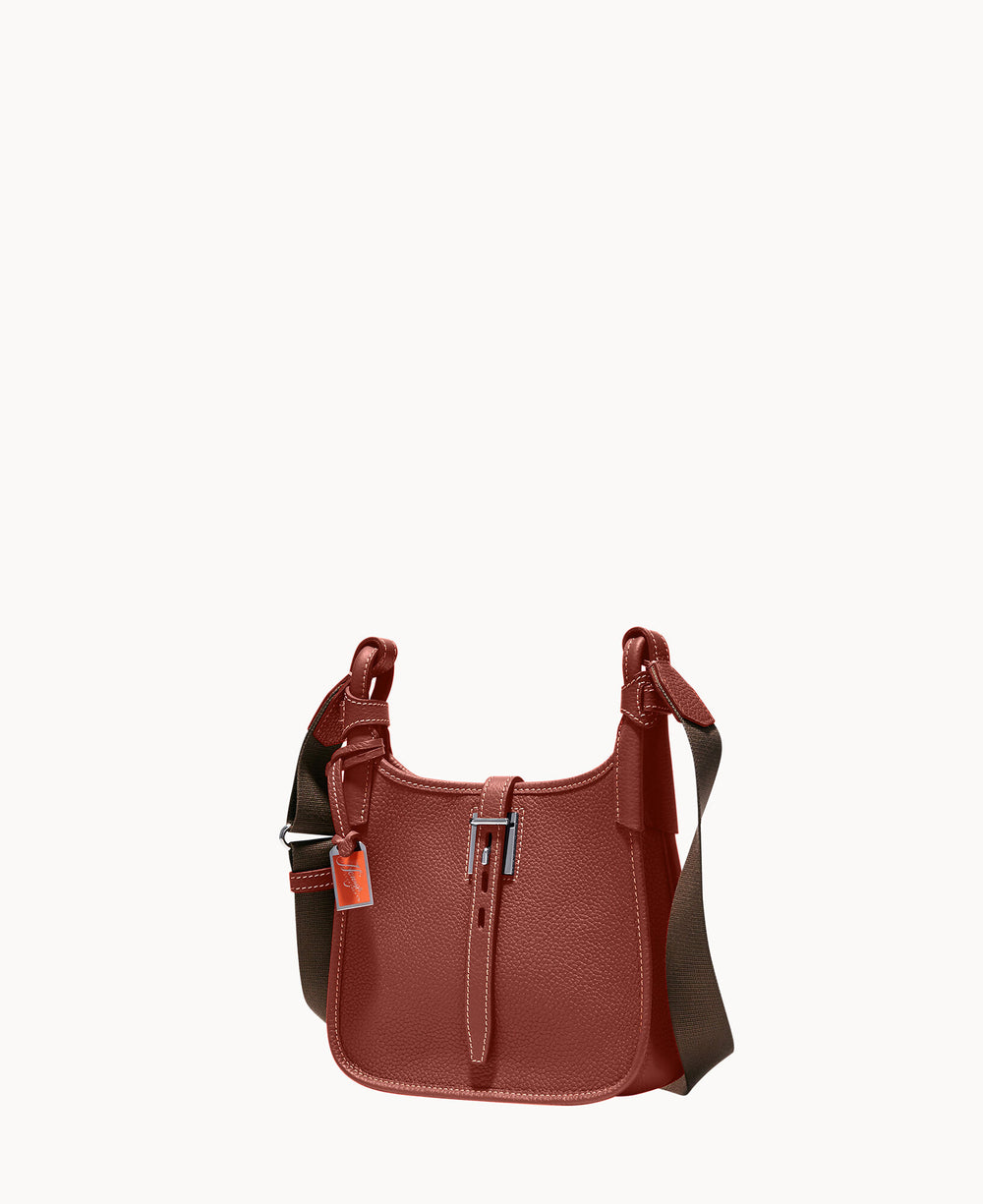 A small, textured, reddish-brown leather shoulder bag with a wide, dark adjustable strap and a visible zipper and tag, set against a plain white background.