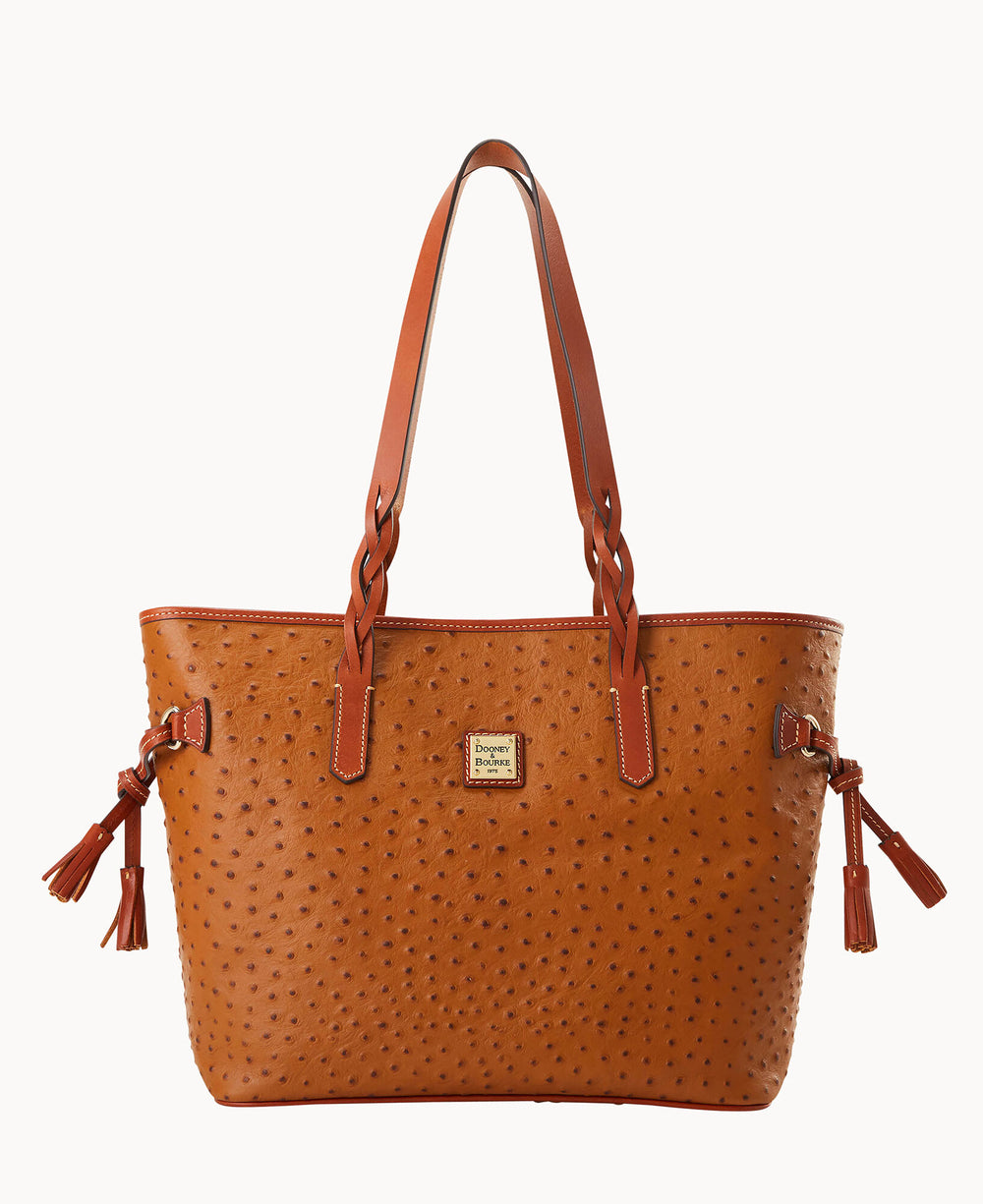 A brown leather tote bag with a textured, ostrich-like pattern, two shoulder straps, side tassels, and a gold Dooney & Bourke logo plate on the front.