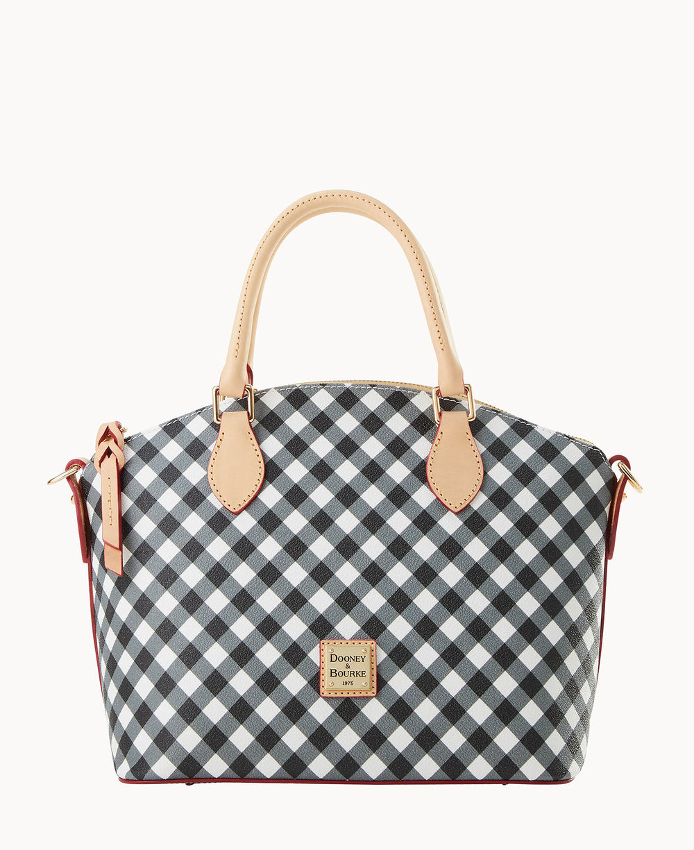 A handbag with tan handles and trim, featuring a black and white checkered pattern and a rectangular Dooney & Bourke logo patch on the front.