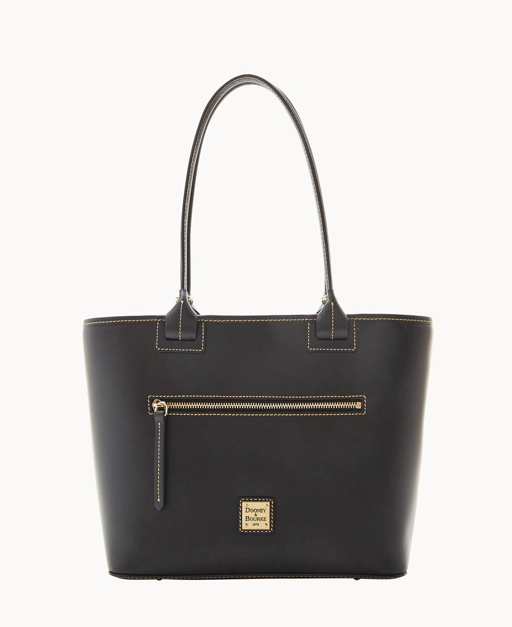 A black leather tote bag with two handles, a front zippered pocket, and a small gold Dooney & Bourke logo plaque near the bottom center. The bag has visible light stitching along the edges.