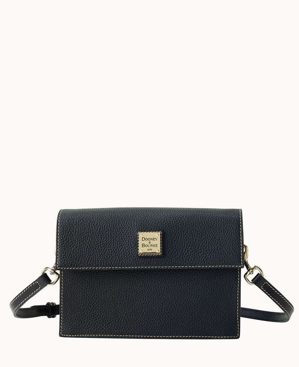 A small black leather crossbody bag with white stitching, a flap closure, gold-tone hardware, and a square Dooney & Bourke logo plaque on the front. The bag has an adjustable shoulder strap.