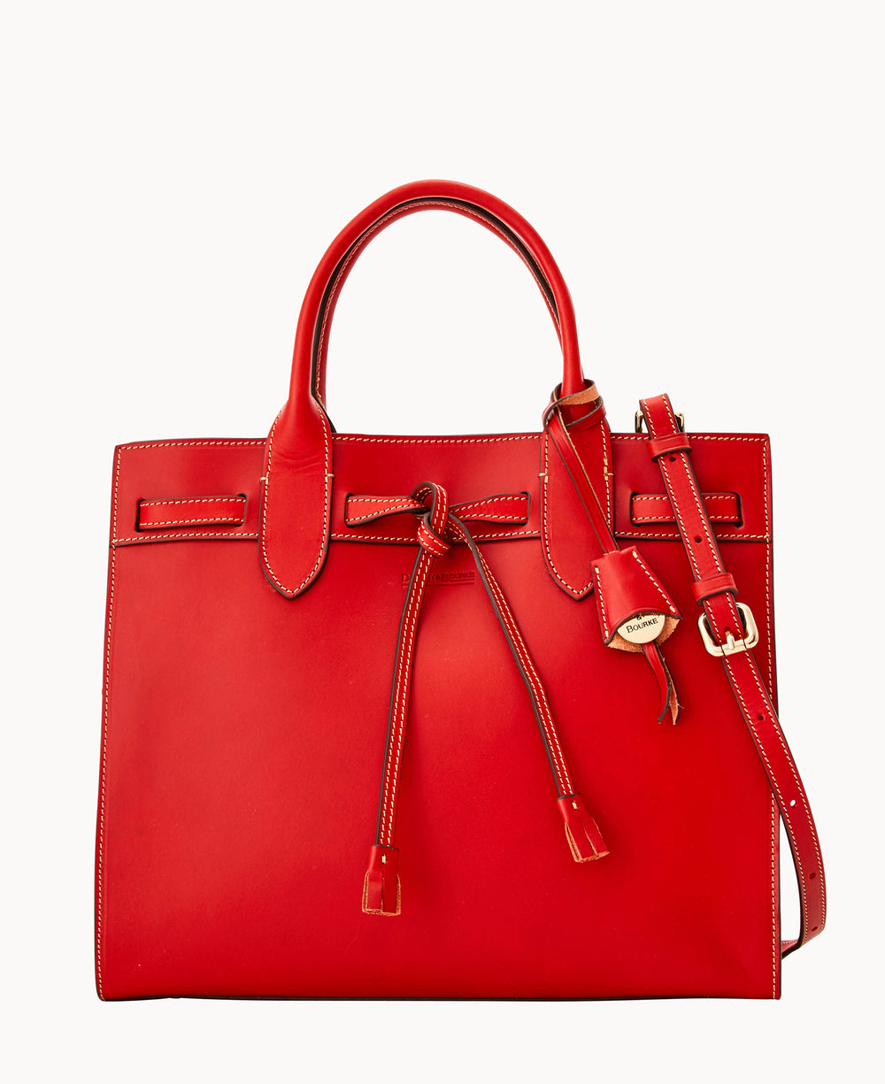 A structured red leather handbag with top handles, a detachable shoulder strap, and a front tie closure. The bag features gold-tone hardware and contrast stitching, set against a plain white background.