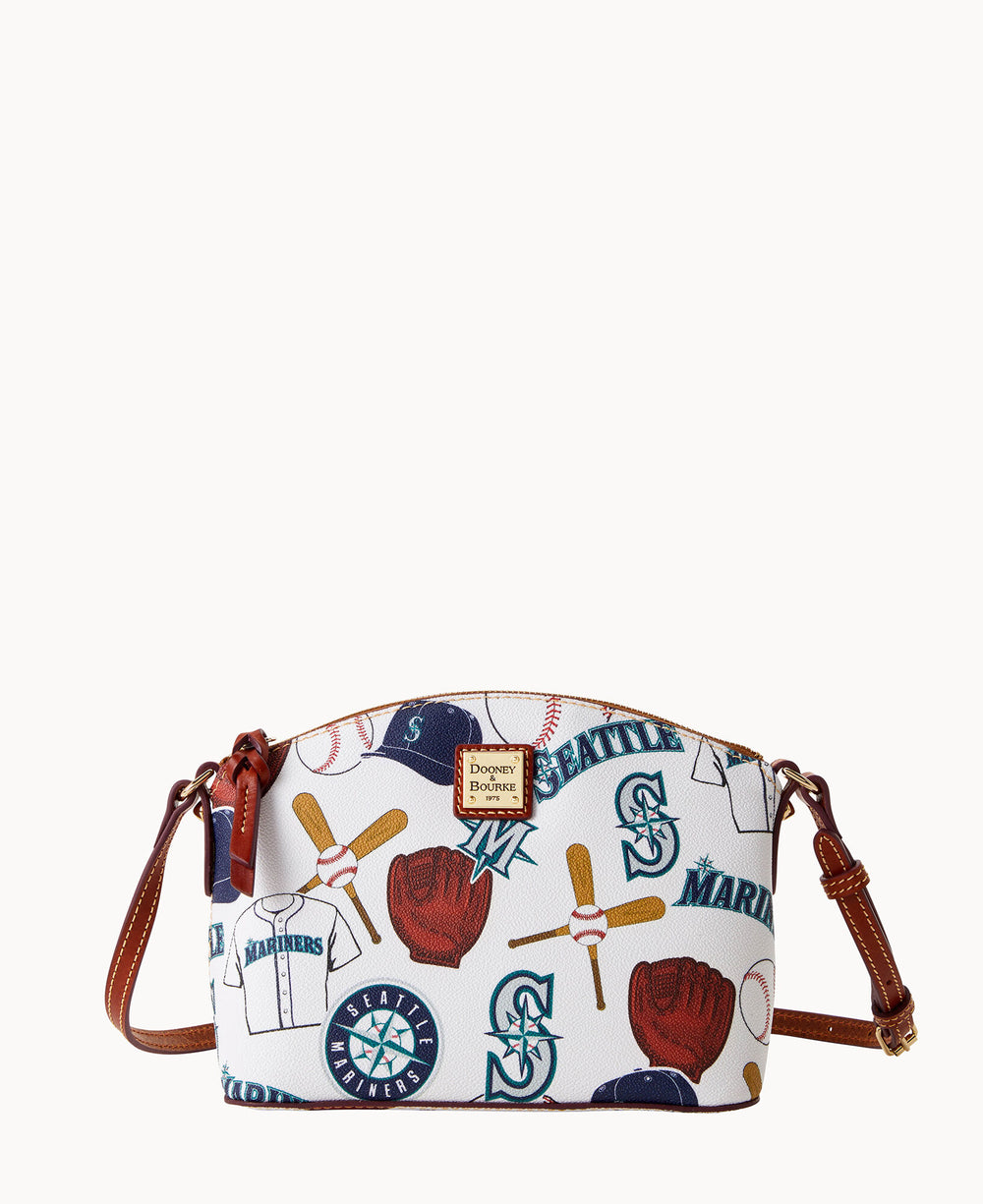 A white crossbody bag with brown leather straps, featuring Seattle Mariners logos, baseballs, bats, gloves, and jerseys in a colorful, playful pattern.