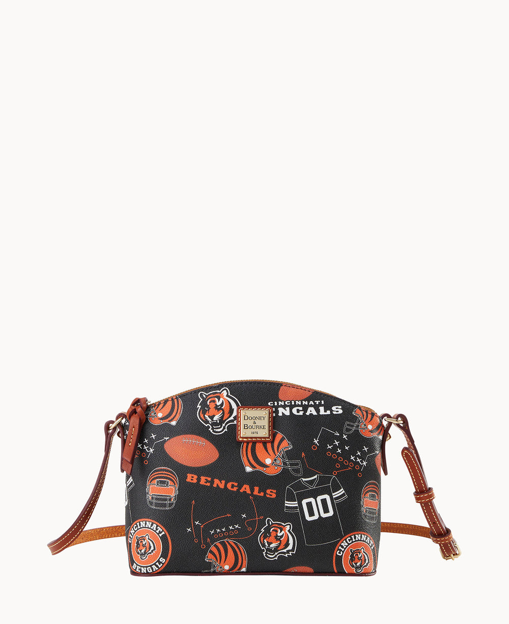A small crossbody bag with brown straps, featuring a Cincinnati Bengals football-themed pattern, including helmets, jerseys, footballs, mascots, and team logos on a black background.