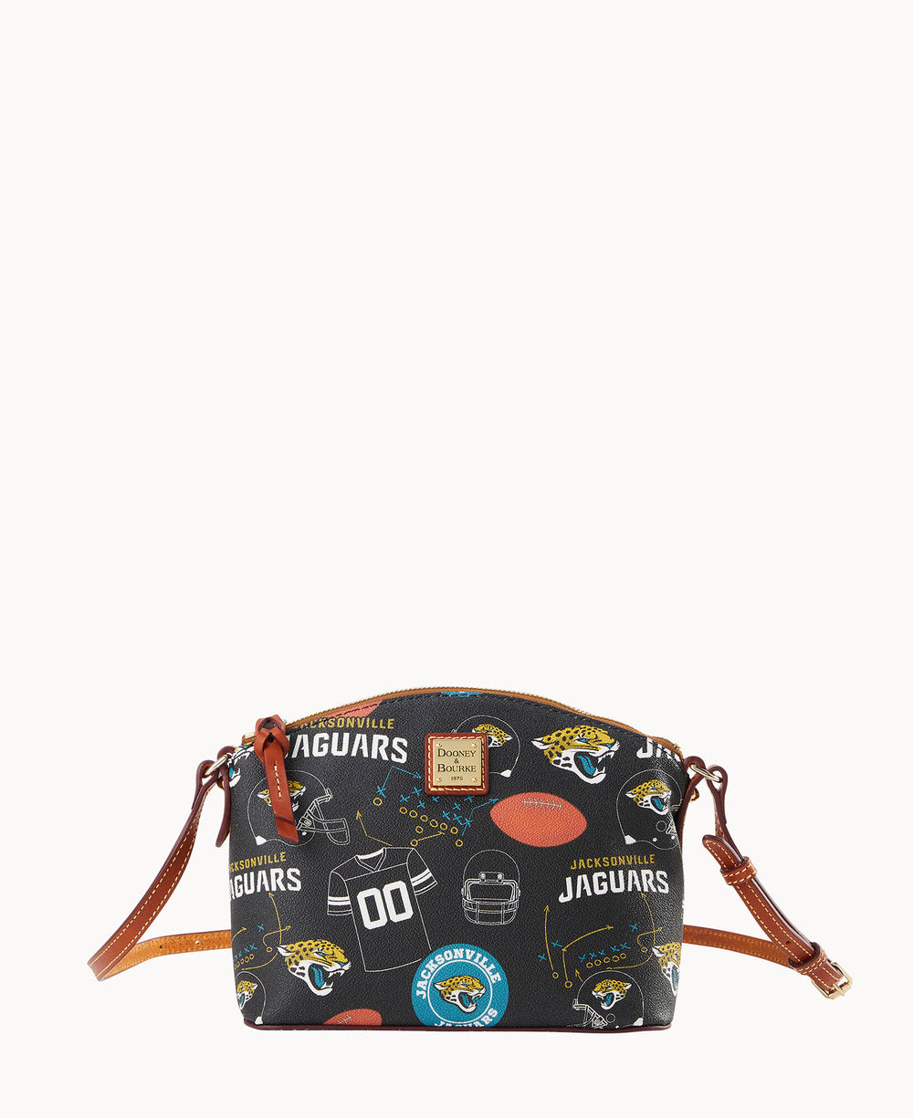 A small black crossbody bag with brown straps, featuring Jacksonville Jaguars logos, footballs, helmets, and text in gold, teal, and white.