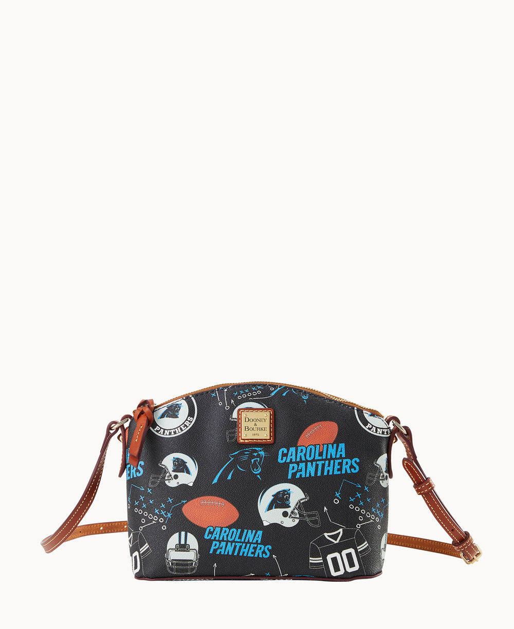 A small black crossbody bag with brown straps, featuring a Carolina Panthers football-themed pattern including helmets, footballs, jerseys, and team logos.
