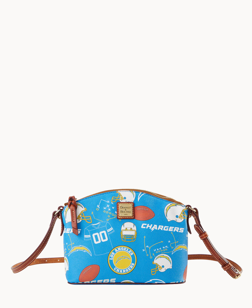 A small blue crossbody purse with brown leather straps, featuring cartoon-style Los Angeles Chargers logos, footballs, helmets, and the word CHARGERS printed across the fabric.