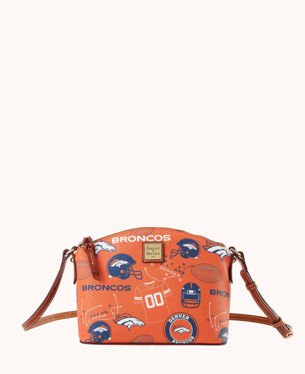 An orange crossbody bag with Denver Broncos logos, footballs, helmets, and related icons, featuring brown leather straps and a gold Dooney & Bourke label on the front.