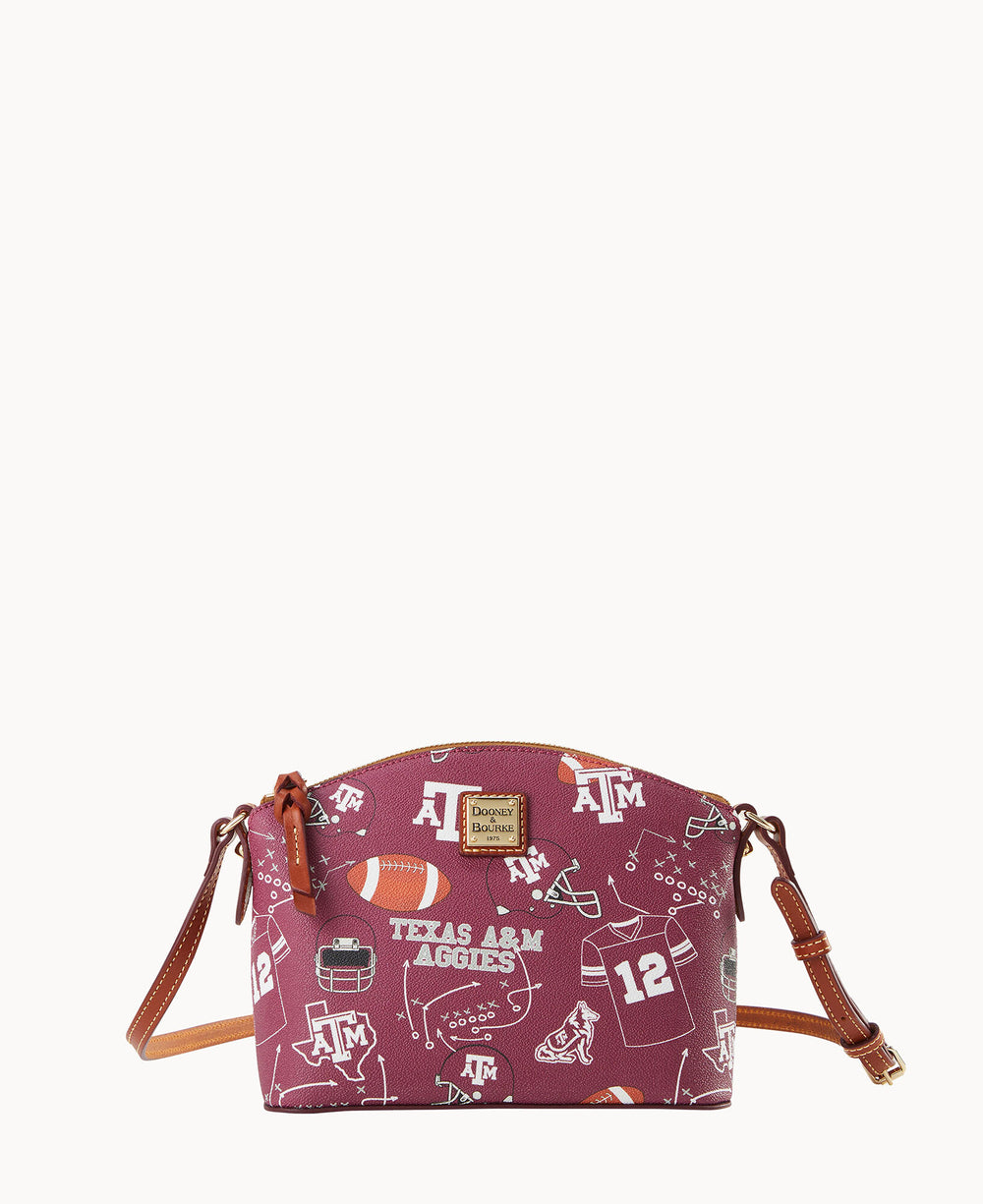 A maroon crossbody bag with brown leather straps featuring Texas A&M Aggies-themed graphics such as footballs, helmets, and the university logo.