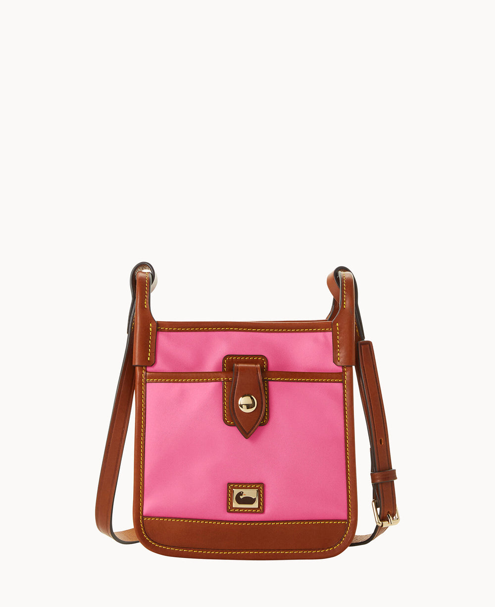 A small crossbody bag with a bright pink body, brown leather trim, gold-tone hardware, front flap pocket, and an adjustable brown leather strap.
