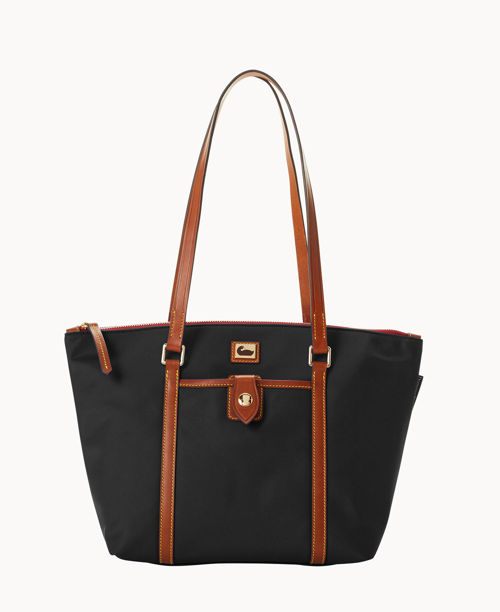 A black tote bag with brown leather handles and trim, featuring a front pocket with a gold clasp and a zippered top closure, displayed on a plain white background.