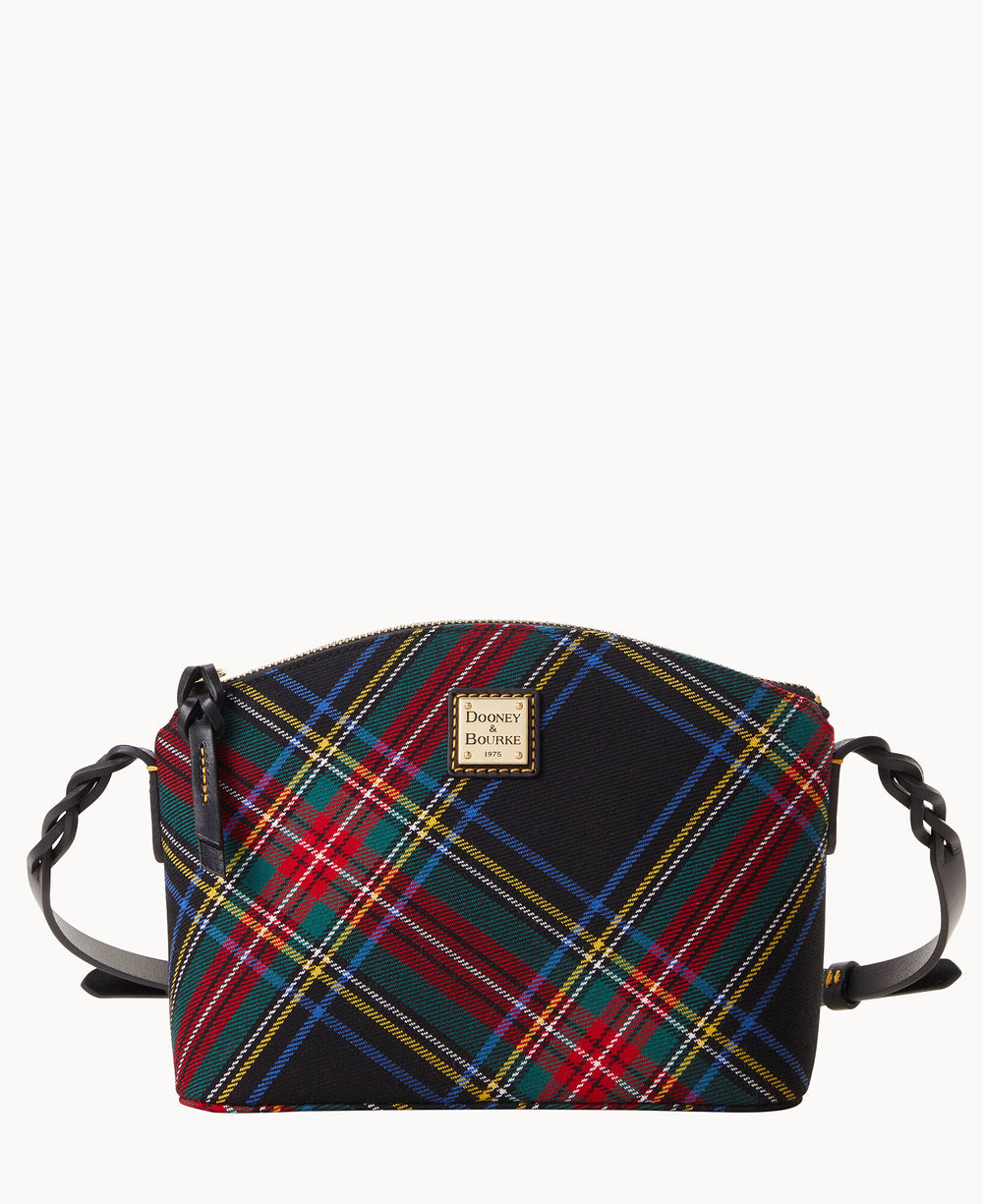 A small, rectangular crossbody bag with a colorful plaid pattern in red, green, blue, and yellow, featuring a gold Dooney & Bourke logo plate and black leather strap with braided detailing.
