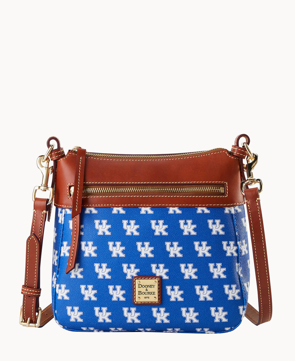 A blue Dooney & Bourke crossbody bag with white UK logos, brown leather trim, gold zipper, and an adjustable strap. The front features a small Dooney & Bourke logo patch.