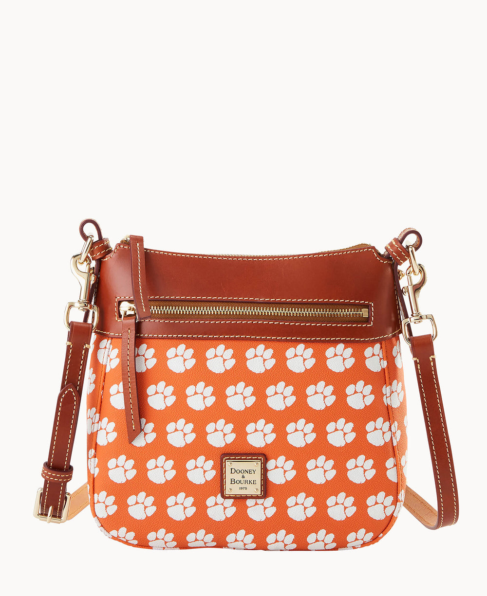 Orange Clemson Tigers crossbody bag featuring white paw prints with brown leather strap and gold hardware