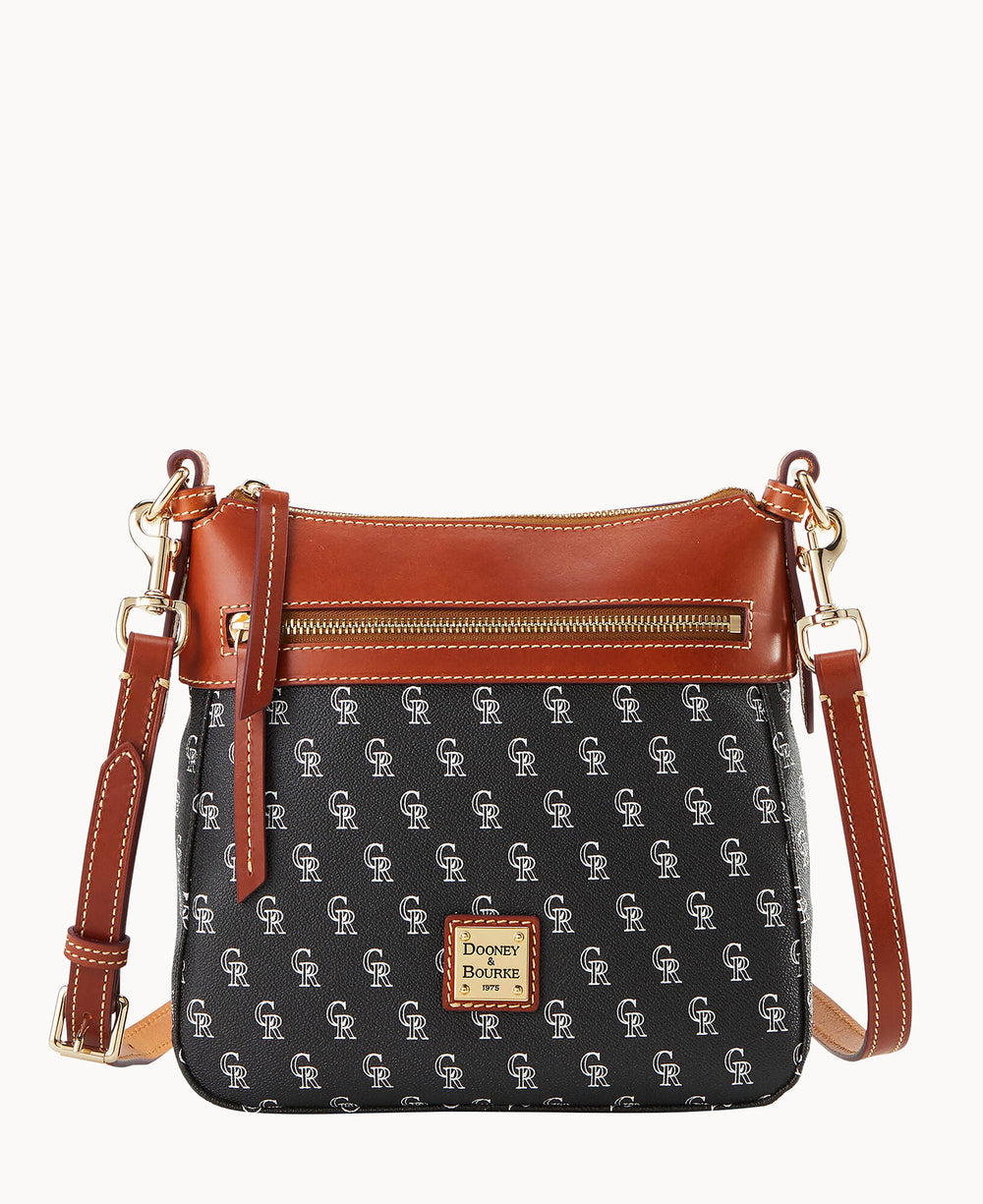 A black Dooney & Bourke crossbody bag with brown leather trim, gold hardware, a front zipper pocket, and a repeating Colorado Rockies CR logo pattern.
