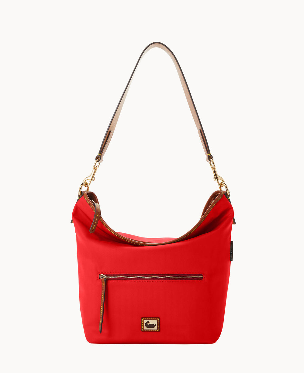 A red hobo-style handbag with a tan and brown leather shoulder strap, gold hardware, a front zipper pocket, and a small rectangular logo patch near the base.