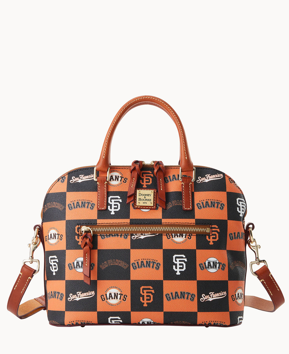 A satchel-style handbag with orange, black, and cream checkerboard pattern featuring San Francisco Giants logos and text, with brown leather handles, trim, and a detachable shoulder strap.