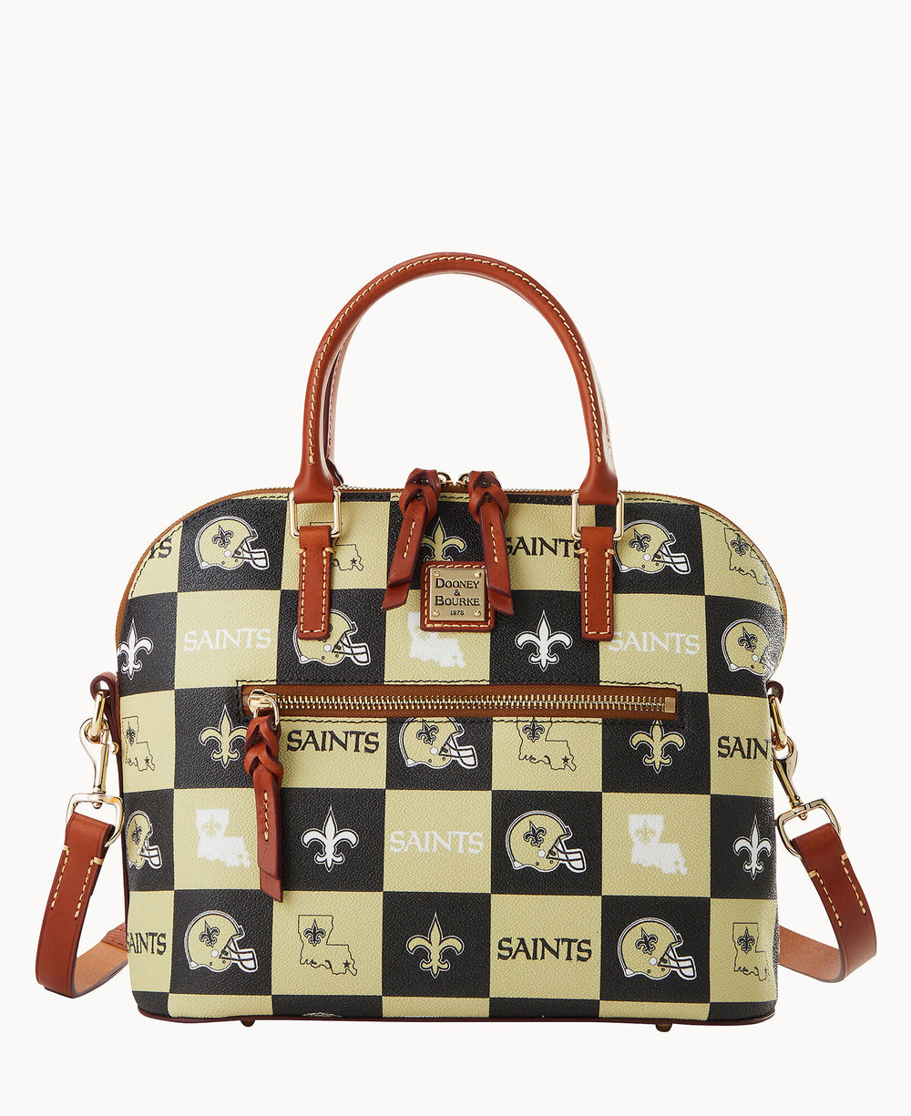 A checkered satchel bag with brown leather handles and gold hardware, featuring New Orleans Saints logos, text, and icons on black and gold squares.